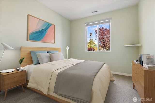carpeted bedroom featuring visible vents and baseboards
