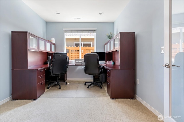 home office featuring visible vents, light carpet, and baseboards