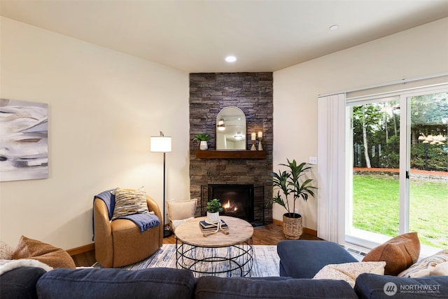 3639 Reagan Ave, Bremerton, WA 98310 - living room with wood finished floors, baseboards, and a stone fireplace