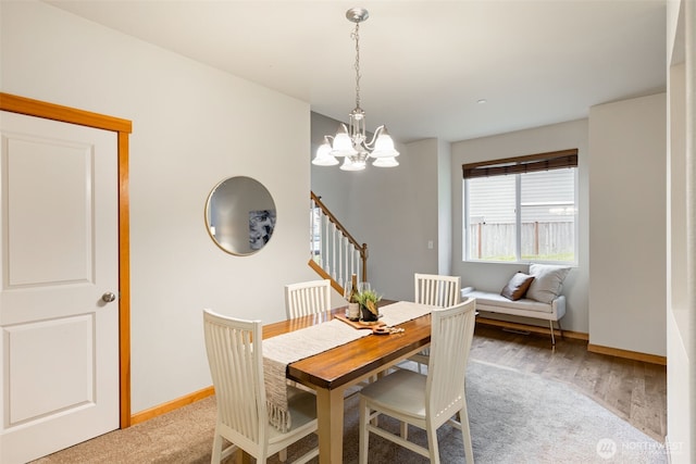 3639 Reagan Ave, Bremerton, WA 98310 - dining room featuring a chandelier, baseboards, stairway, and wood finished floors