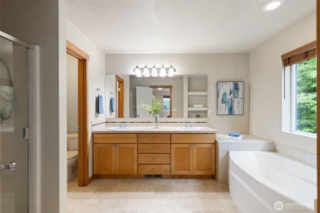 3639 Reagan Ave, Bremerton, WA 98310 - bathroom featuring double vanity, a shower stall, toilet, and a garden tub