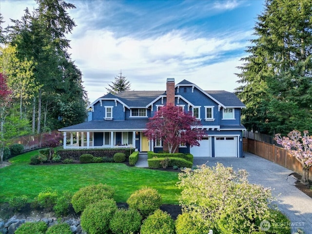 view of front of home with driveway, a chimney, covered porch, fence, and a garage