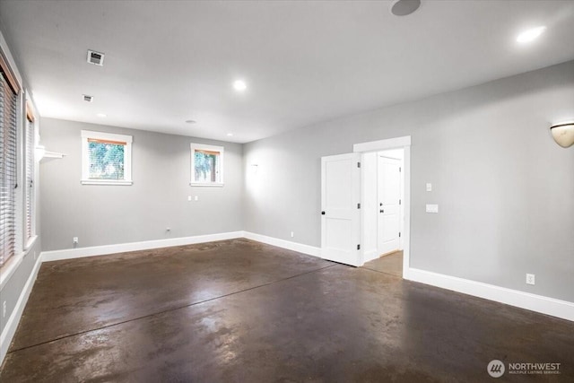 below grade area with baseboards, visible vents, and recessed lighting