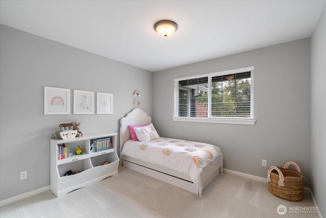 carpeted bedroom featuring baseboards