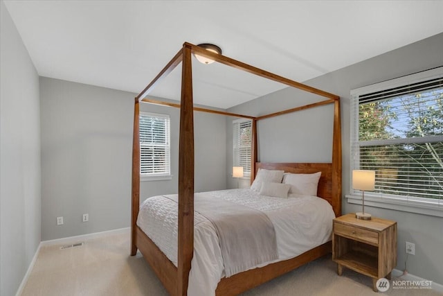 bedroom with baseboards, visible vents, and carpet