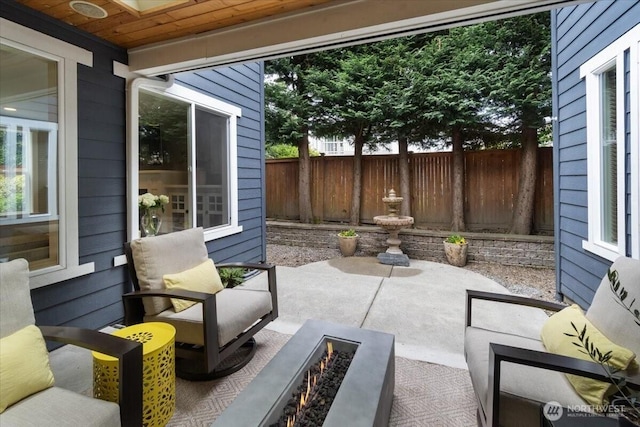 view of patio with fence and an outdoor fire pit