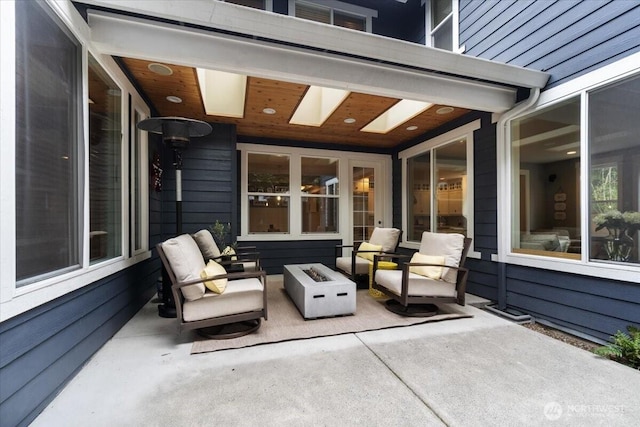 view of patio / terrace with an outdoor living space with a fire pit