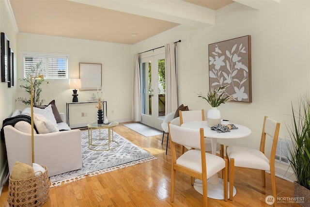living room featuring visible vents, light wood finished floors, and ornamental molding