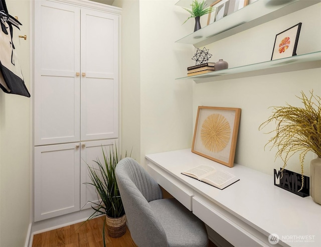 office with built in study area and wood finished floors