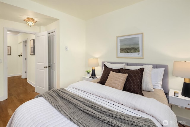 bedroom featuring baseboards and wood finished floors