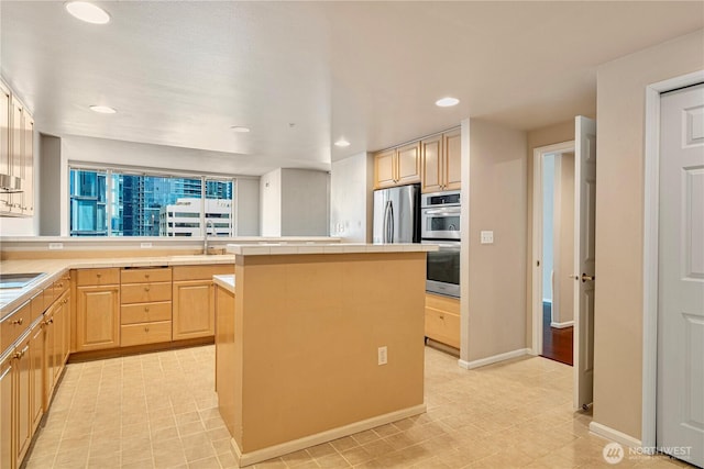 177 107th Ave NE Unit 1501, Bellevue, WA 98004 - kitchen featuring tile counters, light brown cabinets, stainless steel appliances, a kitchen island, and a sink