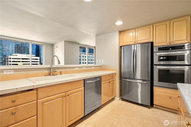 177 107th Ave NE Unit 1501, Bellevue, WA 98004 - kitchen with appliances with stainless steel finishes, a sink, light brown cabinetry, tile countertops, and recessed lighting