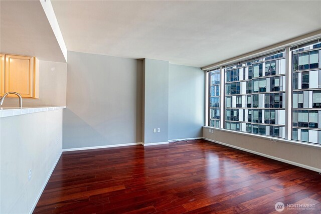 177 107th Ave NE Unit 1501, Bellevue, WA 98004 - empty room with wood finished floors, a sink, and baseboards
