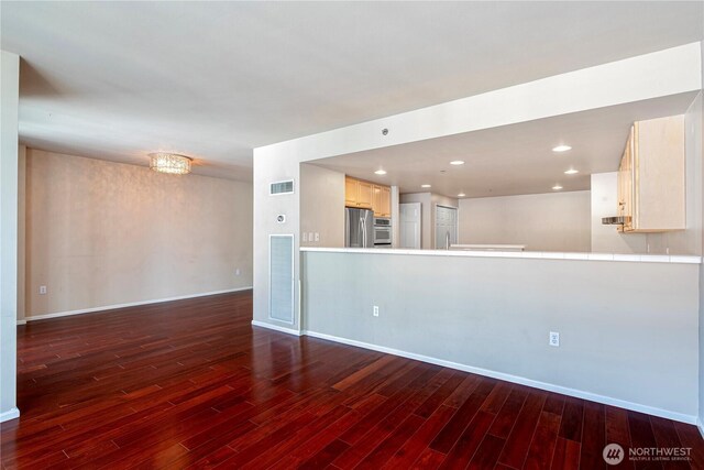 177 107th Ave NE Unit 1501, Bellevue, WA 98004 - unfurnished living room with dark wood-type flooring, baseboards, and recessed lighting