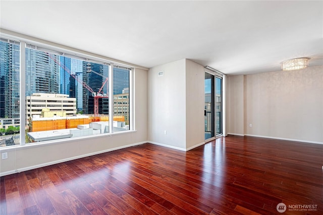 177 107th Ave NE Unit 1501, Bellevue, WA 98004 - empty room with plenty of natural light, wood finished floors, and baseboards
