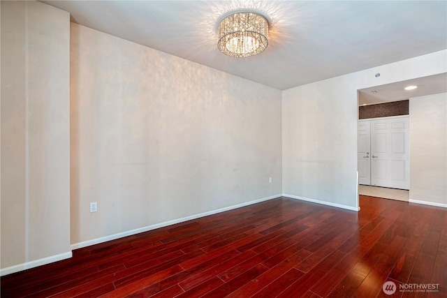 177 107th Ave NE Unit 1501, Bellevue, WA 98004 - unfurnished room with wood finished floors, a chandelier, and baseboards