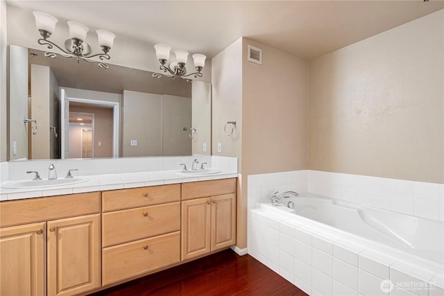 177 107th Ave NE Unit 1501, Bellevue, WA 98004 - full bath with wood finished floors, double vanity, and a garden tub