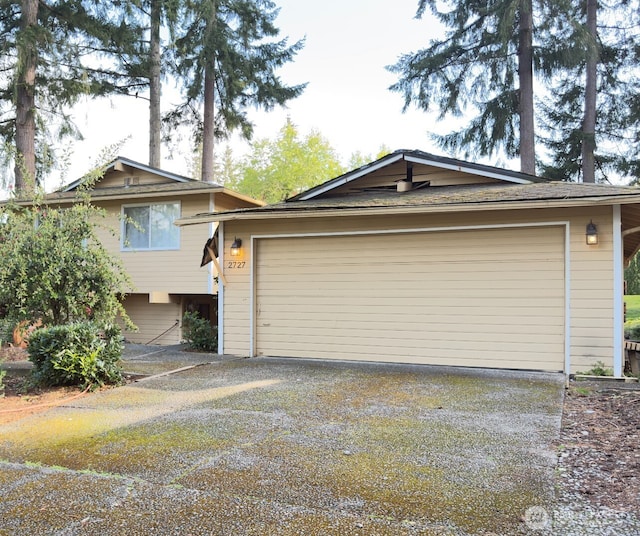 split level home with a garage and driveway