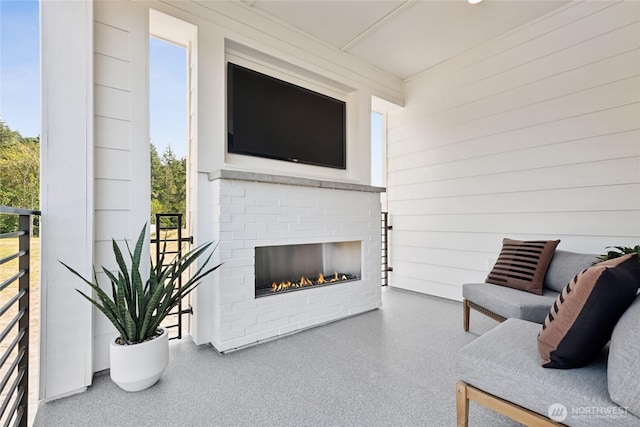 13748 SE 84th St Unit 17, Newcastle, WA 98059 - living area with speckled floor, wood walls, and an outdoor brick fireplace