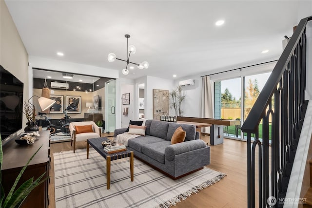13748 SE 84th St Unit 17, Newcastle, WA 98059 - living area featuring recessed lighting, light wood finished floors, an inviting chandelier, a wall unit AC, and stairs