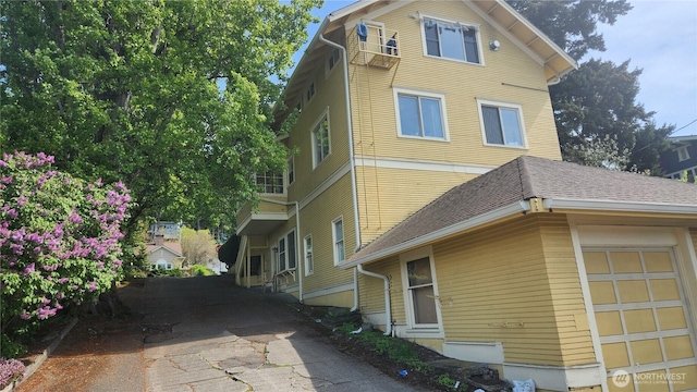 view of side of home with driveway