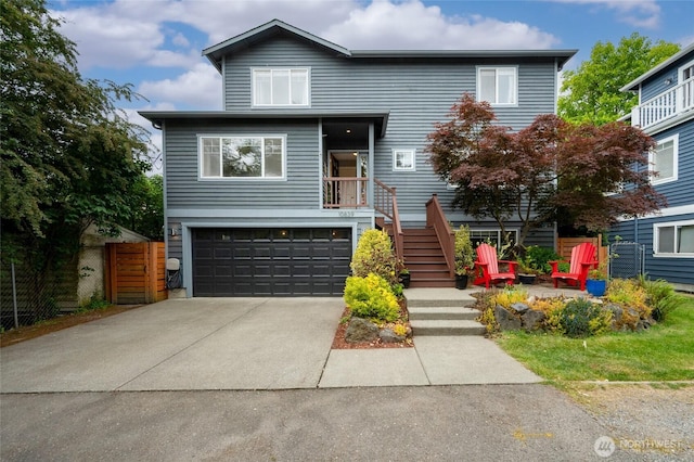 10839 35th Ave SW, Seattle, WA 98146 - view of front of house with a garage, concrete driveway, and stairway