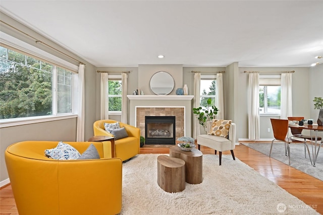 10839 35th Ave SW, Seattle, WA 98146 - living area with plenty of natural light, a fireplace, wood finished floors, and baseboards