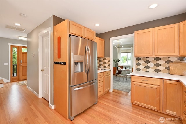 10839 35th Ave SW, Seattle, WA 98146 - kitchen featuring stainless steel fridge, light wood-style floors, light brown cabinets, plenty of natural light, and recessed lighting