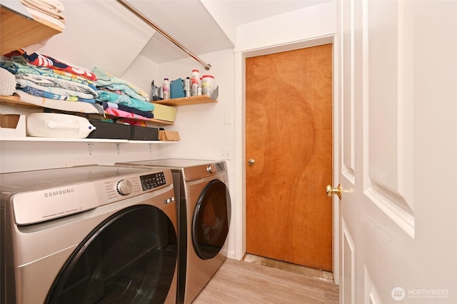 10839 35th Ave SW, Seattle, WA 98146 - laundry area with washer and clothes dryer and light wood-type flooring
