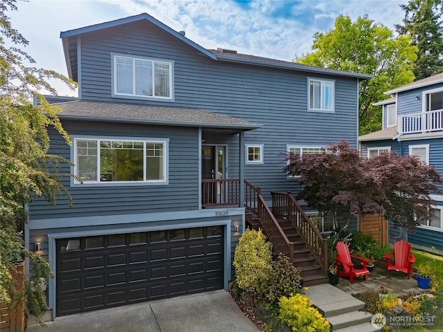 10839 35th Ave SW, Seattle, WA 98146 - traditional-style home featuring a garage, concrete driveway, and stairway