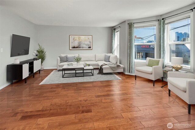 living area with wood finished floors and baseboards