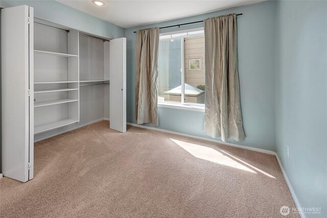 unfurnished bedroom with recessed lighting, carpet floors, a closet, and baseboards