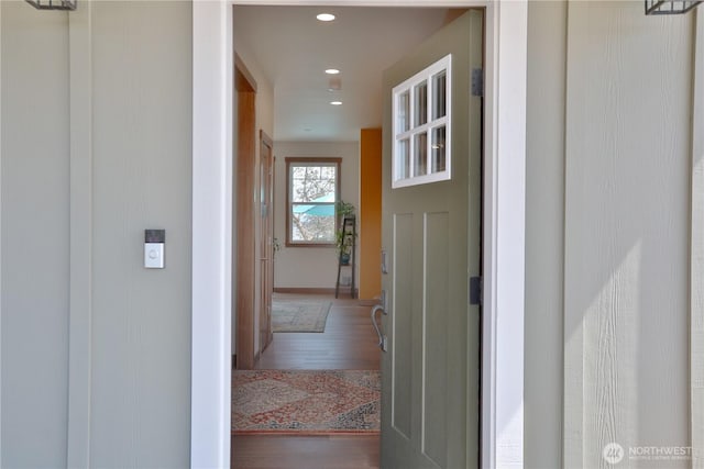 hall featuring recessed lighting, baseboards, and wood finished floors