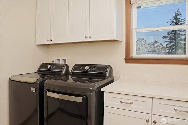 laundry room with cabinet space and washer and clothes dryer