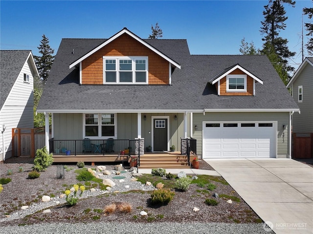 craftsman inspired home featuring fence, an attached garage, board and batten siding, a porch, and concrete driveway