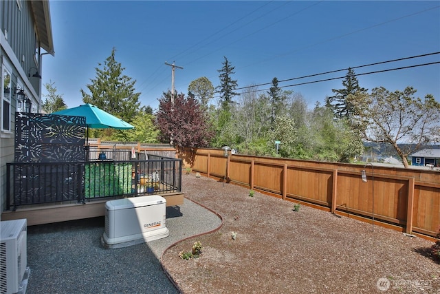 view of yard featuring a fenced backyard, a wooden deck, and ac unit