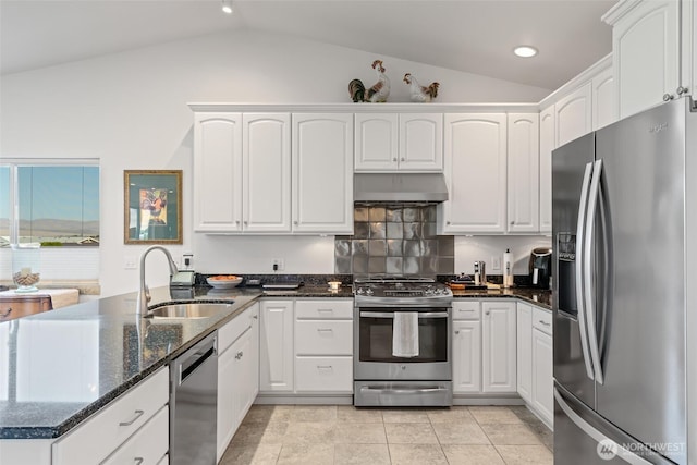 kitchen featuring appliances with stainless steel finishes, a sink, ventilation hood, a peninsula, and lofted ceiling