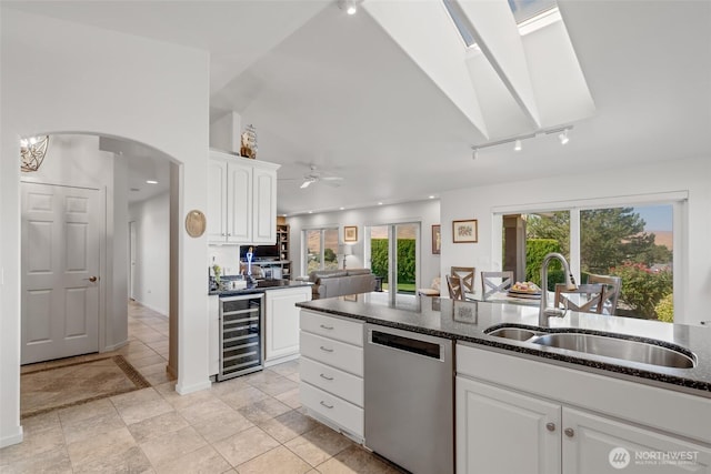 kitchen featuring white cabinetry, a sink, dishwasher, wine cooler, and a ceiling fan