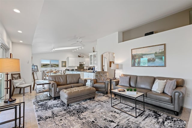 living area featuring arched walkways, light tile patterned flooring, recessed lighting, vaulted ceiling, and a ceiling fan
