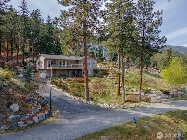 7379 Ridgeview Dr, Chelan, WA 98816 - view of front of house with a garage, driveway, and a wooden deck