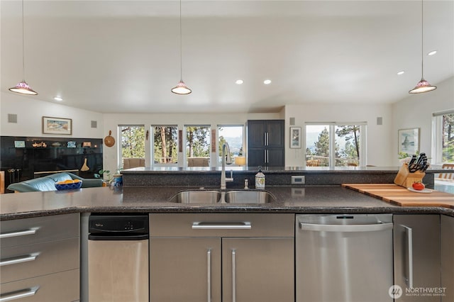 7379 Ridgeview Dr, Chelan, WA 98816 - kitchen featuring dark stone counters, stainless steel dishwasher, a sink, open floor plan, and recessed lighting