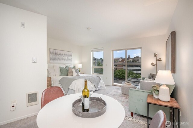 412 11th Ave Unit 309, Seattle, WA 98122 - bedroom featuring visible vents, baseboards, light carpet, and access to exterior