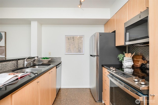 412 11th Ave Unit 309, Seattle, WA 98122 - kitchen featuring light brown cabinets, baseboards, tasteful backsplash, a sink, and appliances with stainless steel finishes