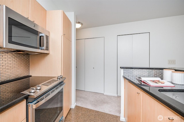 412 11th Ave Unit 309, Seattle, WA 98122 - kitchen with backsplash, appliances with stainless steel finishes, and light brown cabinets