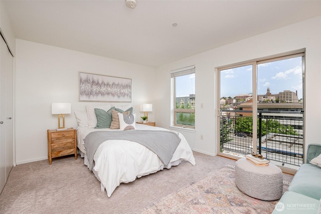 412 11th Ave Unit 309, Seattle, WA 98122 - bedroom featuring access to outside, baseboards, and light carpet