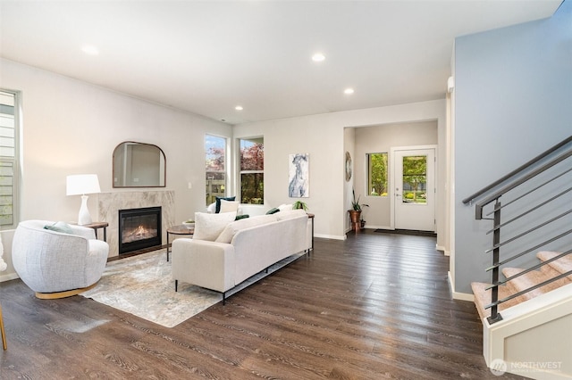 living room with a fireplace, dark wood finished floors, stairs, recessed lighting, and baseboards