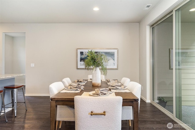 dining room with dark wood-type flooring, recessed lighting, and baseboards