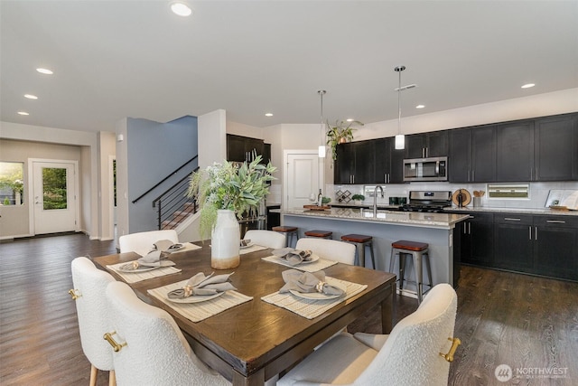 dining space featuring stairway, dark wood-style floors, and recessed lighting