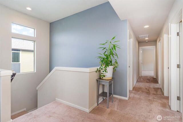 hall featuring an upstairs landing, carpet floors, recessed lighting, and baseboards