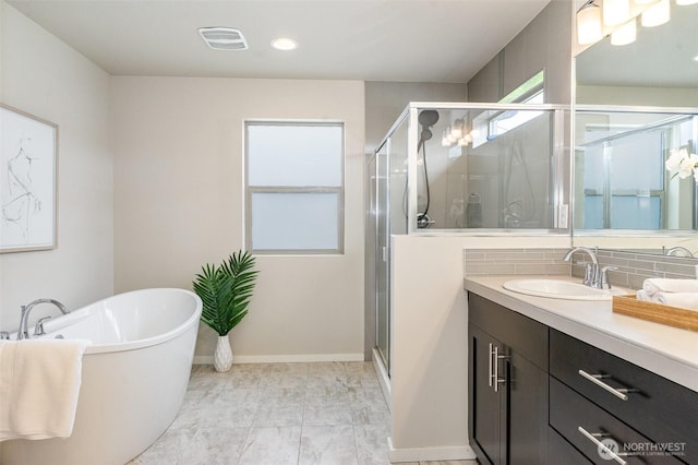 full bathroom featuring a shower stall, decorative backsplash, vanity, a freestanding bath, and marble look tile flooring